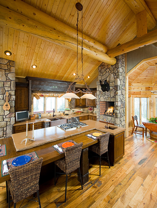 Inspiration for a large rustic medium tone wood floor eat-in kitchen remodel with a farmhouse sink, raised-panel cabinets, medium tone wood cabinets, concrete countertops, brown backsplash, terra-cotta backsplash and an island