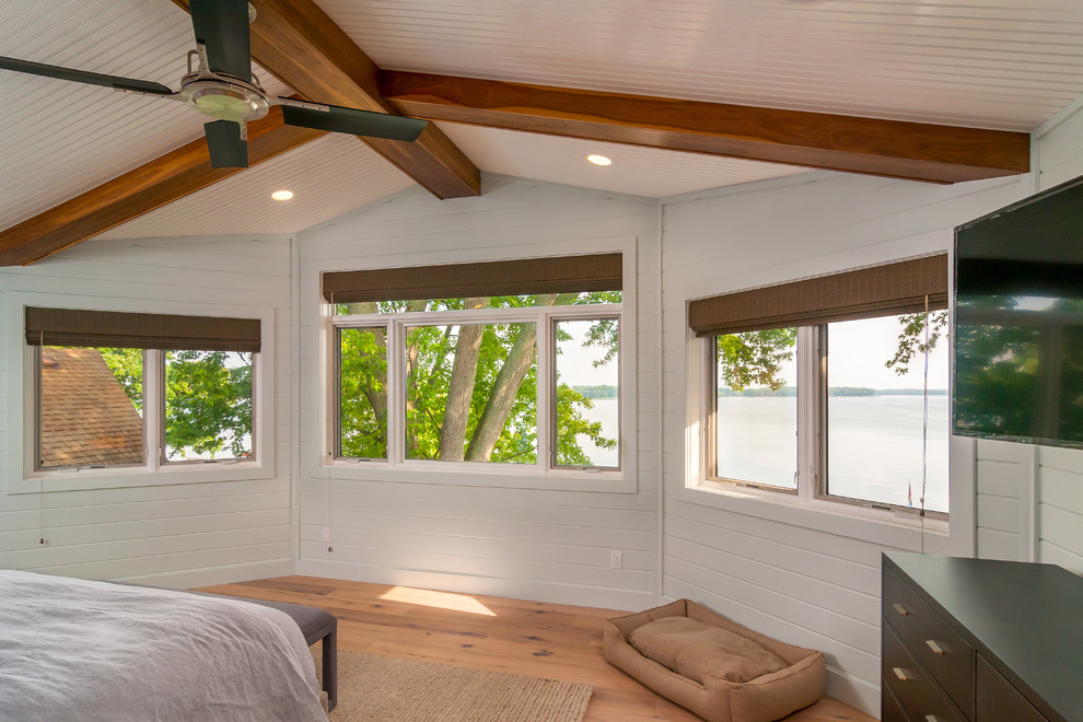 Large transitional master light wood floor and beige floor bedroom photo with white walls