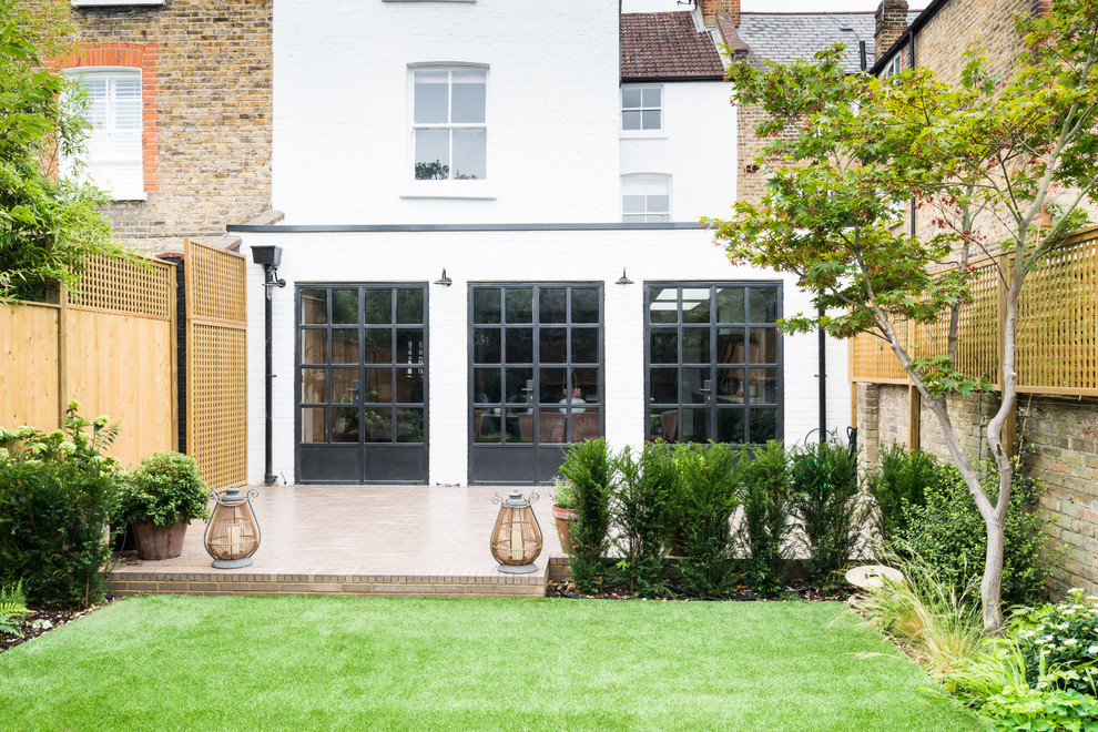 This is an example of an expansive transitional patio in London.
