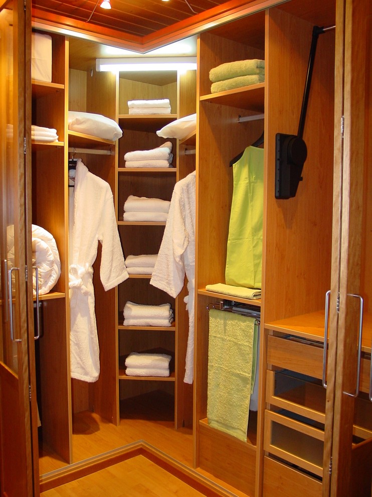 This is an example of a small transitional gender-neutral walk-in wardrobe in Other.