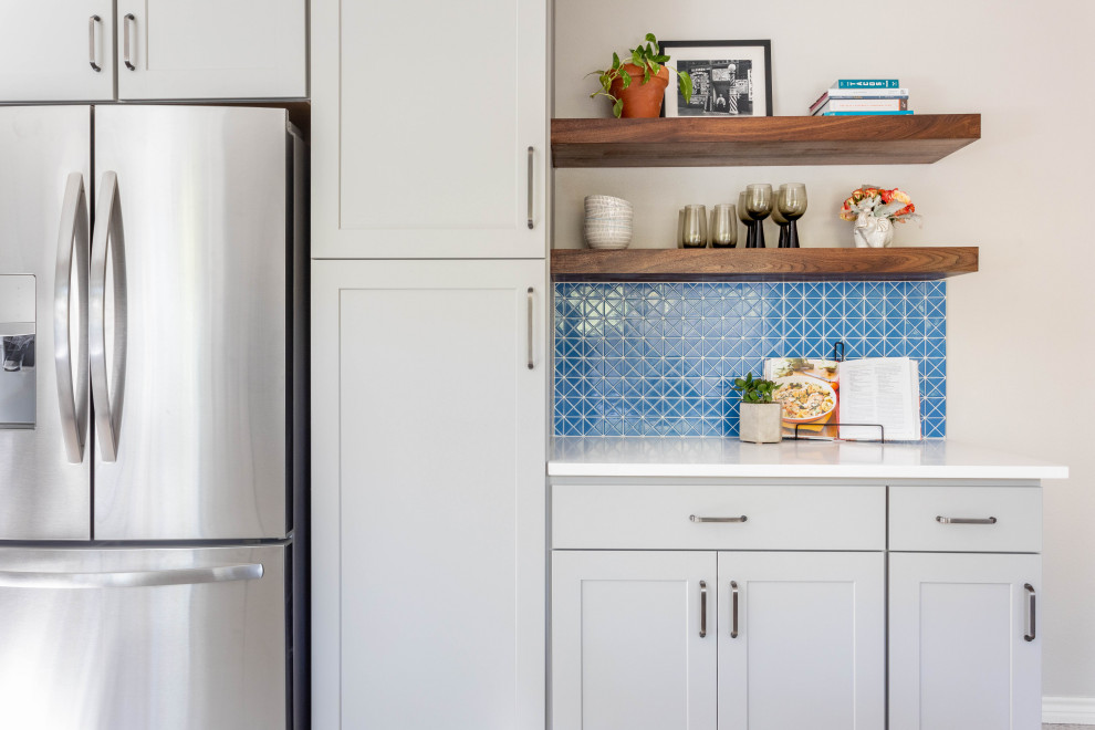 Enclosed kitchen - mid-sized transitional u-shaped terrazzo floor and multicolored floor enclosed kitchen idea in Austin with a double-bowl sink, shaker cabinets, gray cabinets, quartz countertops, blue backsplash, ceramic backsplash, stainless steel appliances, no island and white countertops