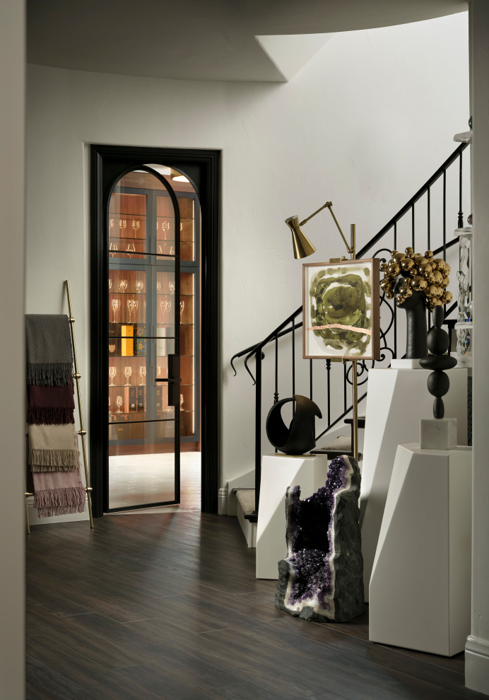 Example of a large transitional dark wood floor and brown floor wine cellar design in Denver with display racks
