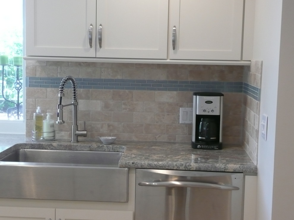Example of a mid-sized transitional u-shaped eat-in kitchen design in Miami with a farmhouse sink, flat-panel cabinets, white cabinets, quartzite countertops, beige backsplash, stone tile backsplash, stainless steel appliances and a peninsula