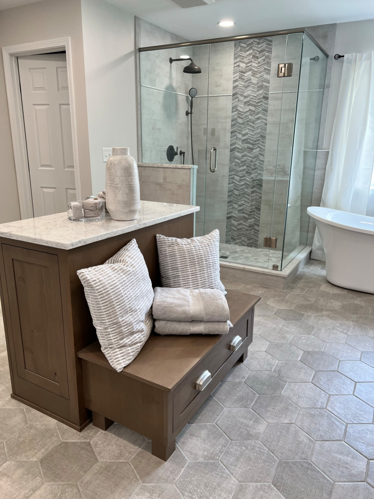 Large transitional master white tile and porcelain tile porcelain tile and gray floor freestanding bathtub photo in Cincinnati with medium tone wood cabinets, white walls, quartz countertops, a hinged shower door, white countertops and a built-in vanity