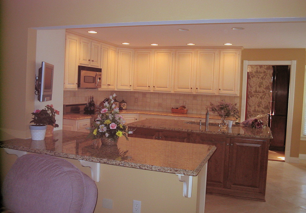 Inspiration for a transitional ceramic tile eat-in kitchen remodel in Philadelphia with an undermount sink, raised-panel cabinets, granite countertops, multicolored backsplash, ceramic backsplash, stainless steel appliances and an island