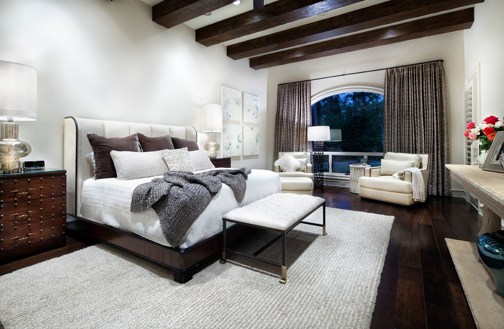 This is an example of a contemporary bedroom in Houston with white walls, dark hardwood floors and brown floor.