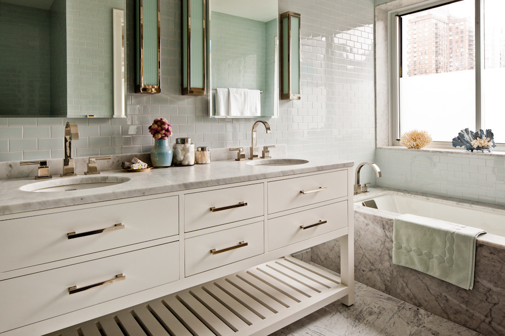 Design ideas for a large contemporary master bathroom in New York with marble benchtops, subway tile, an undermount sink, flat-panel cabinets, white cabinets, an undermount tub, an alcove shower, blue tile, marble floors, blue walls, grey floor and grey benchtops.
