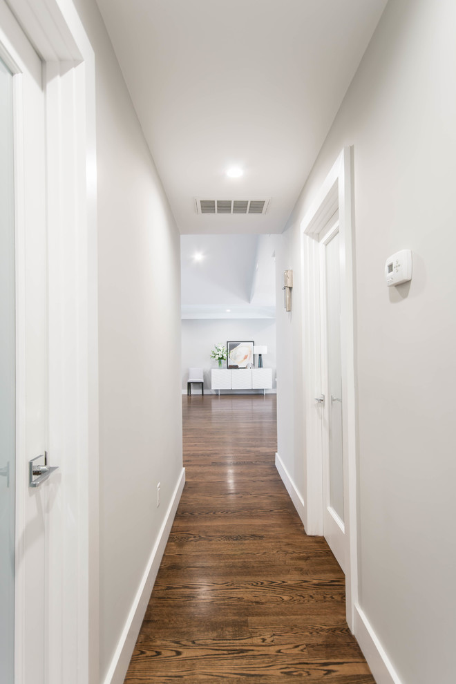 Photo of a mid-sized transitional hallway in Providence with grey walls, dark hardwood floors and brown floor.