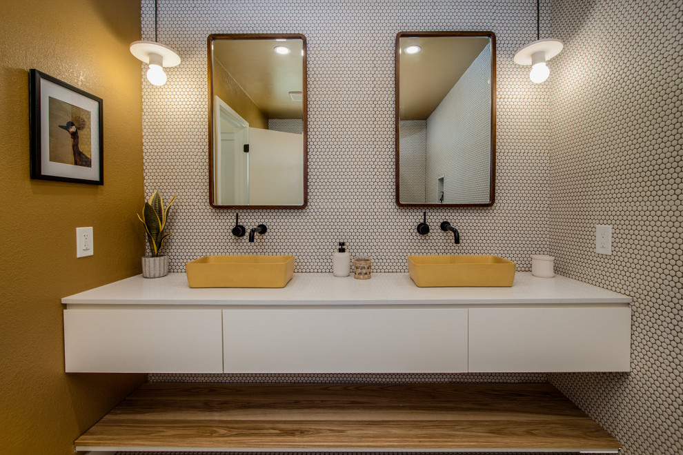 Photo of a mediterranean master bathroom in Los Angeles with flat-panel cabinets, white cabinets, a curbless shower, white tile, mosaic tile, yellow walls, mosaic tile floors, a vessel sink, engineered quartz benchtops, white floor, an open shower, white benchtops, a niche, a double vanity and a floating vanity.