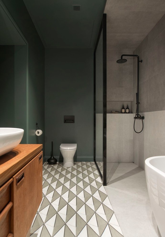 This is an example of a large contemporary 3/4 bathroom in Saint Petersburg with a freestanding tub, an open shower, a two-piece toilet, gray tile, porcelain tile, green walls, cement tiles, a vessel sink, multi-coloured floor and an open shower.