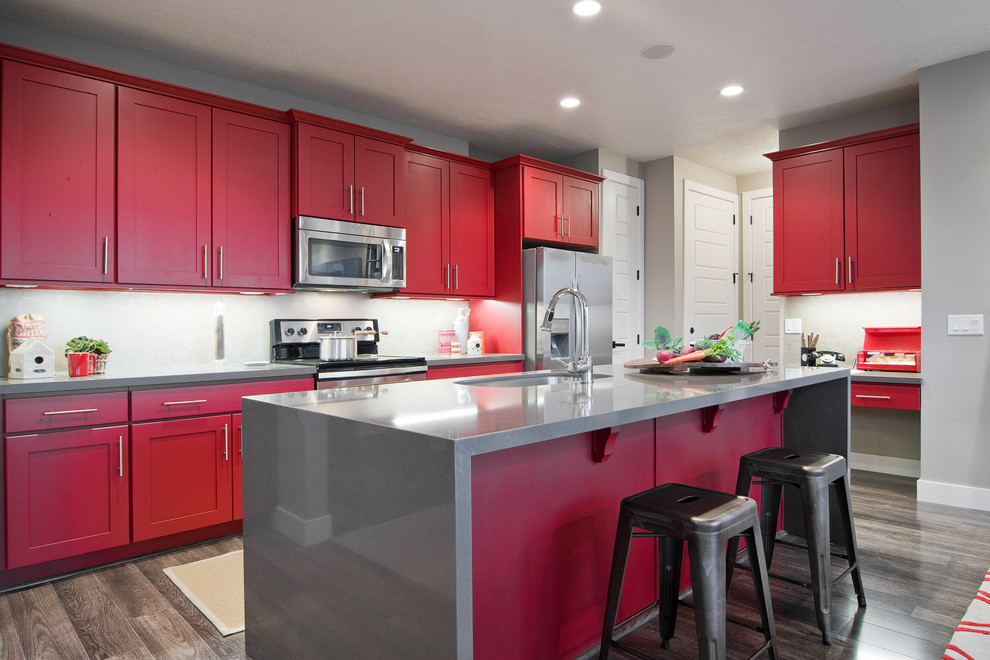 Inspiration for a contemporary single-wall eat-in kitchen in Salt Lake City with an undermount sink, shaker cabinets, red cabinets, stainless steel appliances, with island and quartzite benchtops.