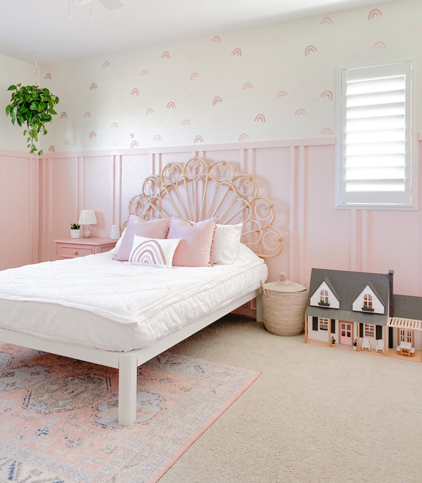 This is an example of a country kids' bedroom for girls in Denver with pink walls and wainscoting.