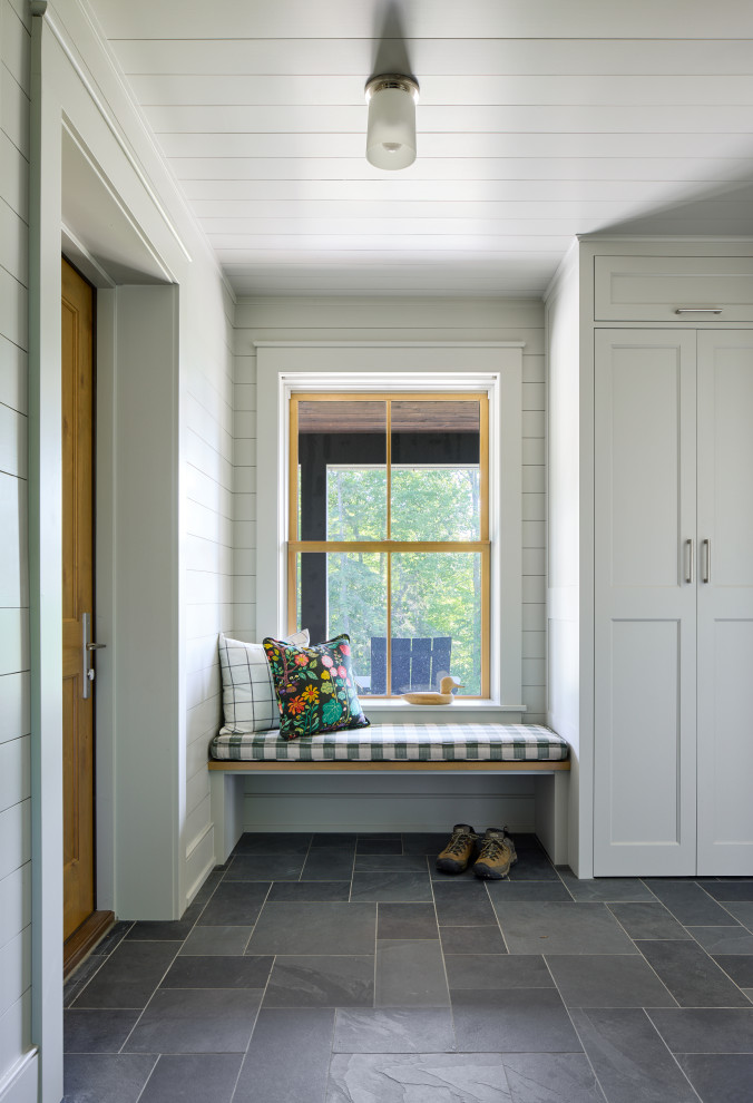 Example of a beach style slate floor, shiplap ceiling and shiplap wall mudroom design in Minneapolis