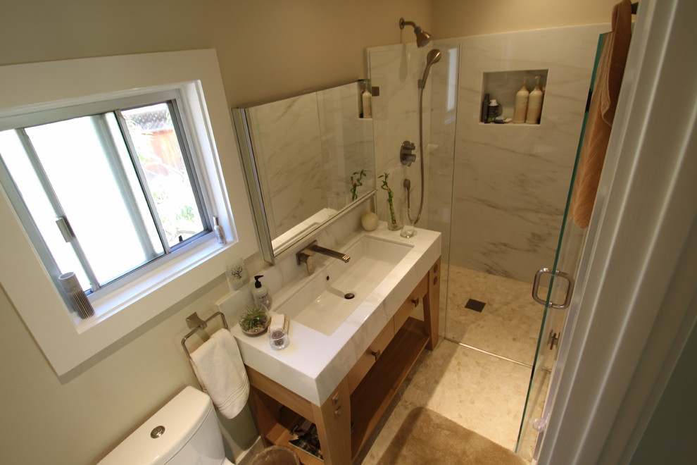 Small transitional 3/4 bathroom in San Francisco with a trough sink, light wood cabinets, marble benchtops, a curbless shower, a two-piece toilet, beige tile, pebble tile and pebble tile floors.