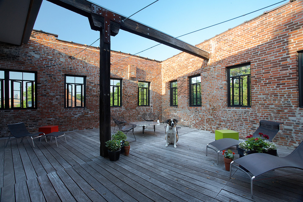 Photo of a mid-sized industrial rooftop and rooftop deck in St Louis with a container garden and no cover.