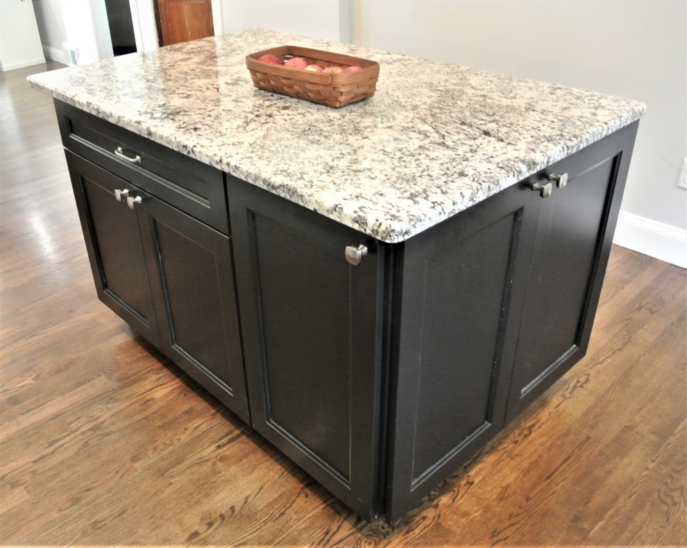 Eat-in kitchen - transitional l-shaped medium tone wood floor and brown floor eat-in kitchen idea in Boston with an undermount sink, shaker cabinets, white cabinets, granite countertops, beige backsplash, subway tile backsplash, stainless steel appliances, an island and beige countertops