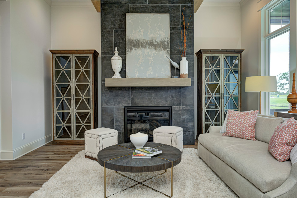 Family room - mid-sized transitional open concept vinyl floor, brown floor and exposed beam family room idea in Indianapolis with white walls, a standard fireplace and a tile fireplace