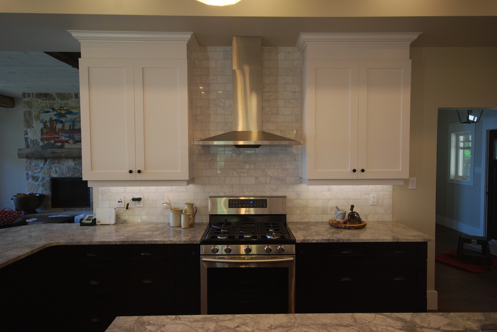 Example of a large transitional galley medium tone wood floor open concept kitchen design in Ottawa with a farmhouse sink, shaker cabinets, dark wood cabinets, quartzite countertops, white backsplash, stone tile backsplash and stainless steel appliances