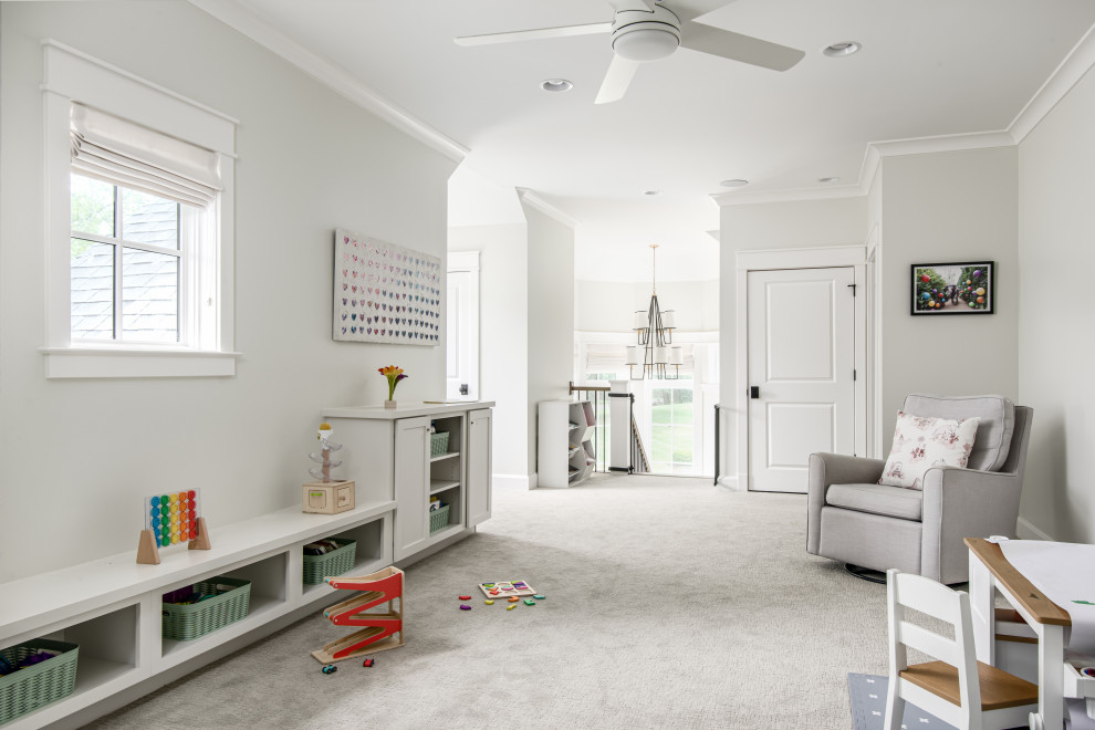 Klassisk inredning av ett mellanstort könsneutralt småbarnsrum kombinerat med lekrum, med vita väggar, heltäckningsmatta och grått golv