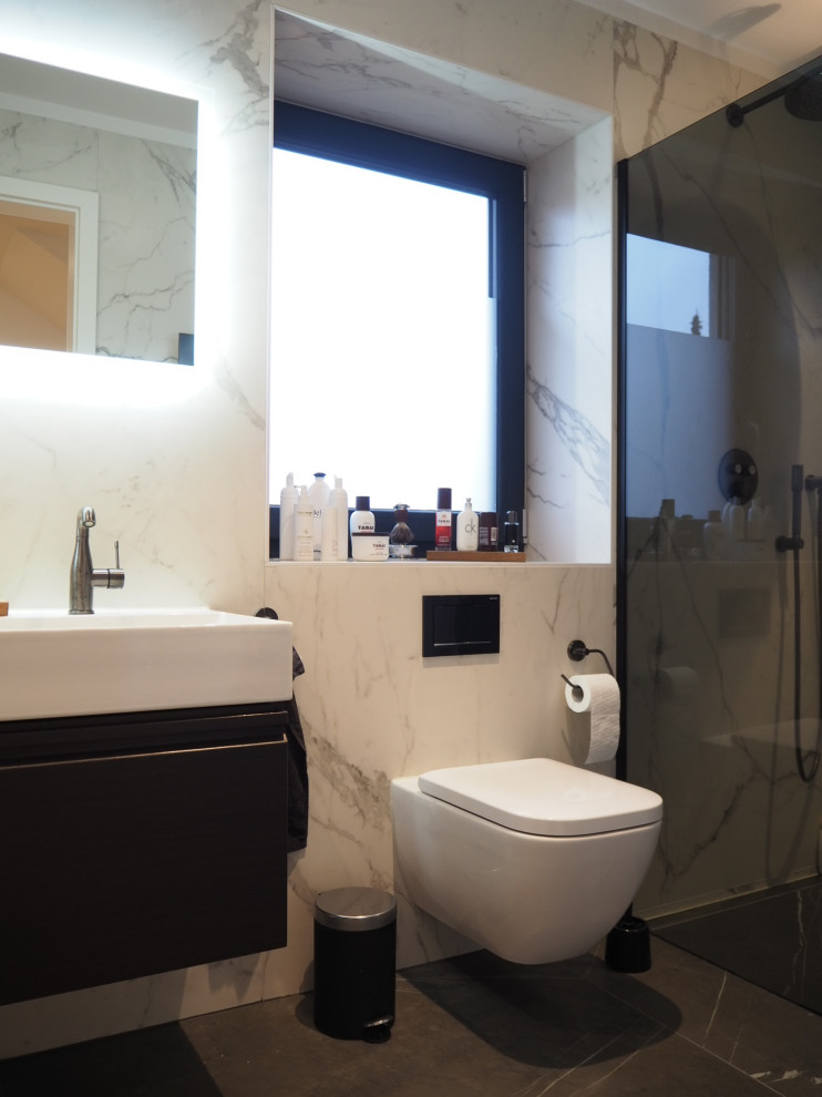 This is an example of a mid-sized modern bathroom in Munich with flat-panel cabinets, dark wood cabinets, a wall-mount toilet, black and white tile, ceramic tile, white walls, ceramic floors, a console sink, grey floor, a double vanity and a floating vanity.