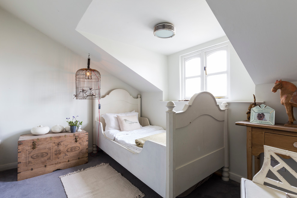 This is an example of a traditional kids' bedroom for kids 4-10 years old and girls in London with white walls and concrete floors.