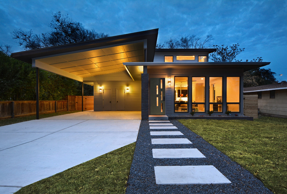 Inspiration for a mid-sized midcentury two-storey grey exterior in Austin with wood siding and a gable roof.