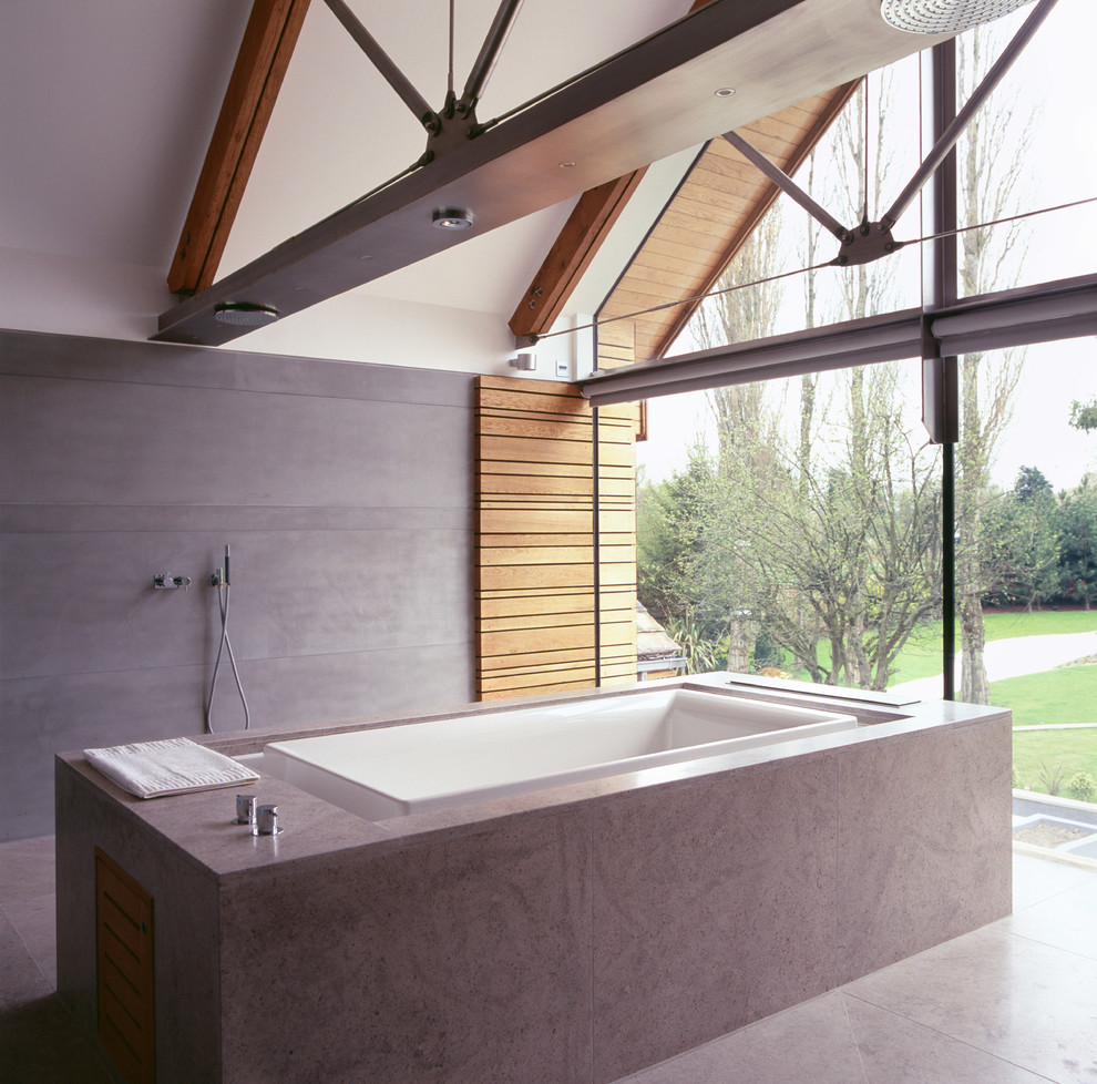 Photo of a contemporary ensuite bathroom in Manchester with a freestanding bath, a walk-in shower, grey tiles, stone tiles, white walls and an open shower.