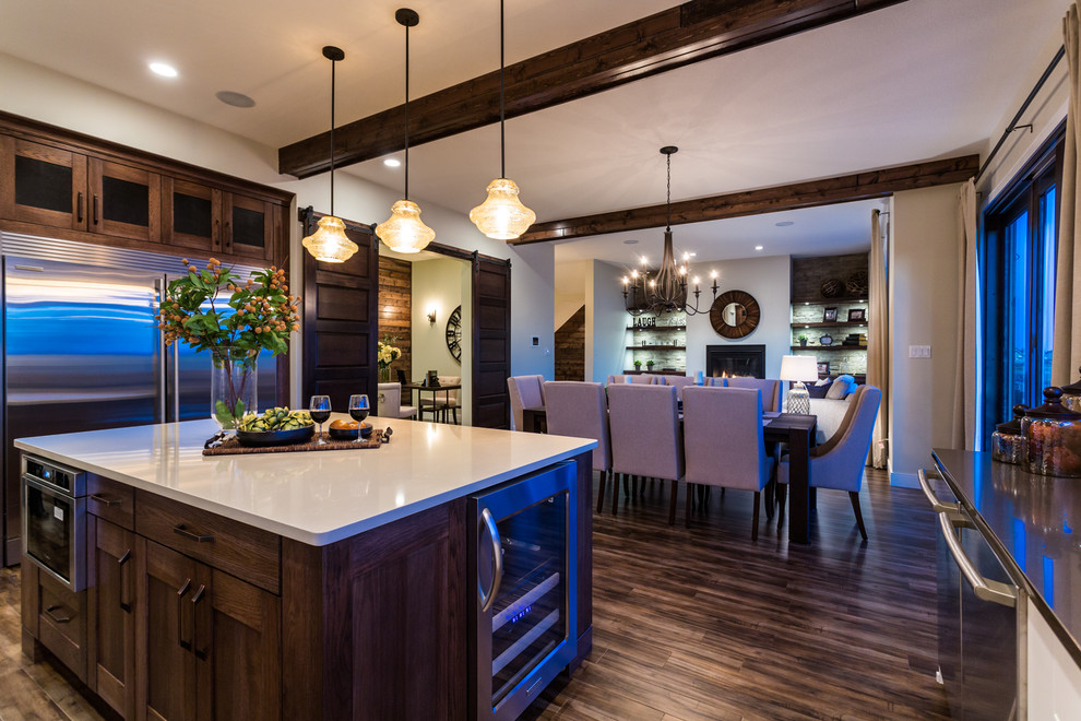 Eat-in kitchen - large transitional u-shaped dark wood floor eat-in kitchen idea in Calgary with an undermount sink, shaker cabinets, white cabinets, quartz countertops, brown backsplash, ceramic backsplash, stainless steel appliances and an island
