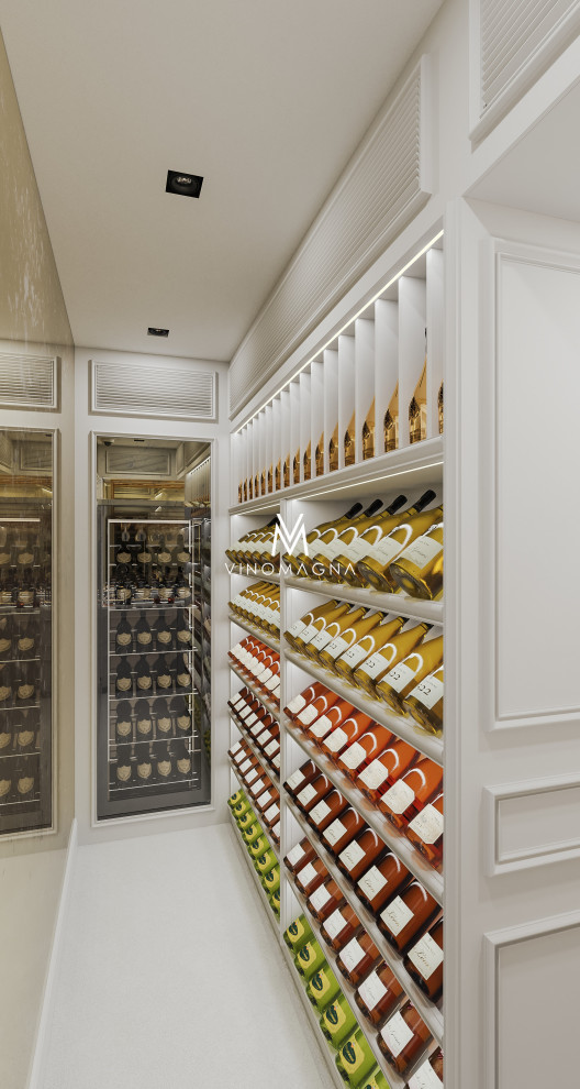 Large modern wine cellar in London with porcelain flooring, display racks, white floors and a feature wall.