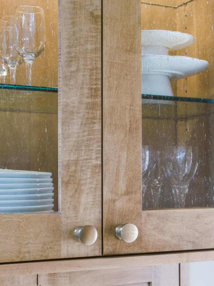 Mid-sized transitional l-shaped medium tone wood floor and brown floor open concept kitchen photo in Chicago with an undermount sink, glass-front cabinets, medium tone wood cabinets, quartz countertops, white backsplash, ceramic backsplash, stainless steel appliances, an island and white countertops