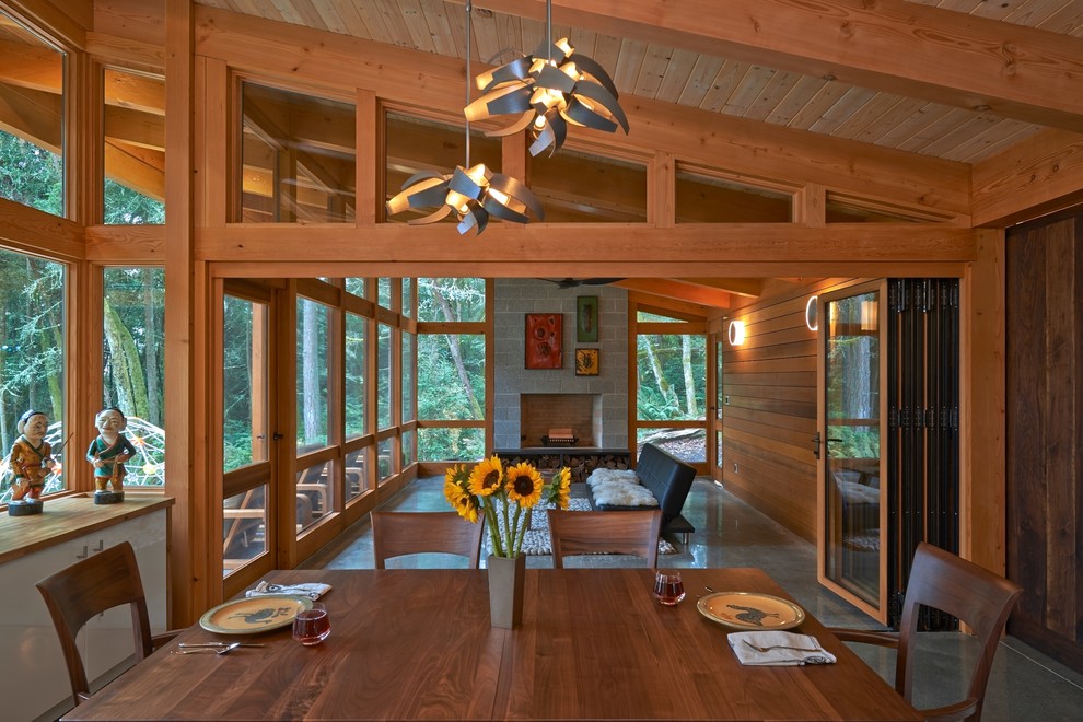 This is an example of a country dining room in Seattle with grey floor.