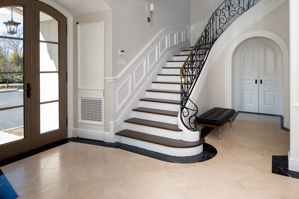 Inspiration for a large traditional foyer in New York with white walls, limestone floors and a double front door.