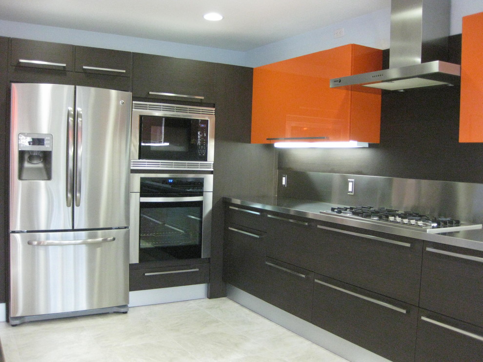 This is an example of a contemporary u-shaped eat-in kitchen in San Diego with an integrated sink, flat-panel cabinets, orange cabinets, stainless steel benchtops, brown splashback, metal splashback, stainless steel appliances and porcelain floors.