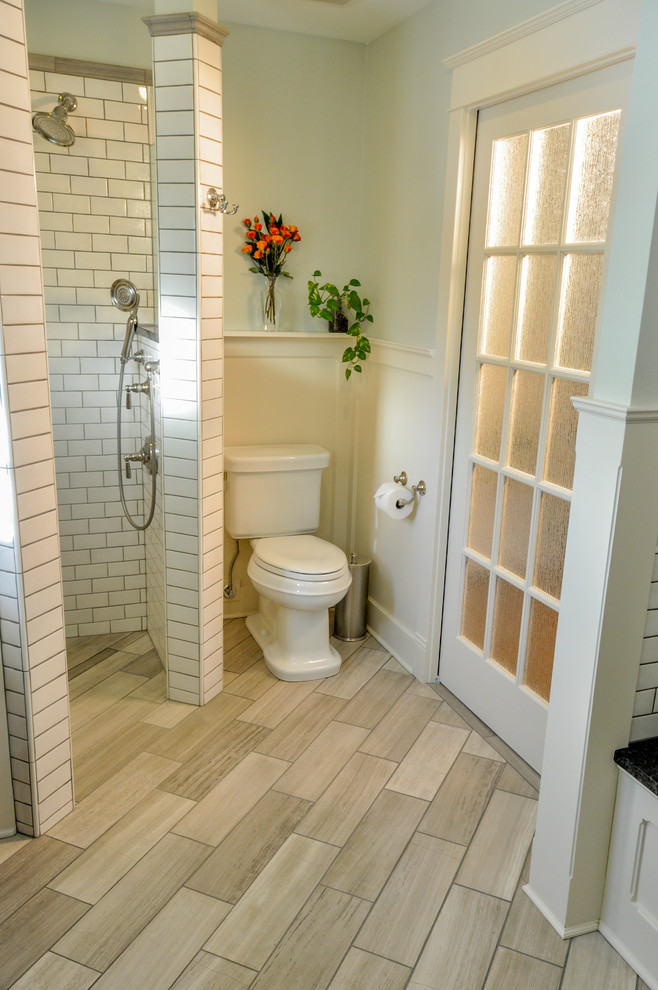 Inspiration for a mid-sized arts and crafts master bathroom in Richmond with an undermount sink, beaded inset cabinets, white cabinets, granite benchtops, an undermount tub, a corner shower, a two-piece toilet, beige tile, glass tile, green walls and limestone floors.