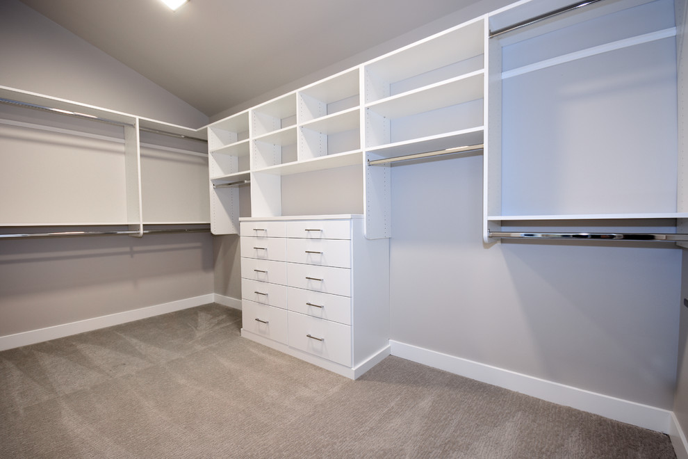 Design ideas for a large contemporary gender-neutral walk-in wardrobe in Seattle with open cabinets, white cabinets, carpet and grey floor.