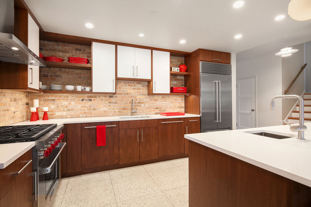 Inspiration for a mid-sized midcentury l-shaped eat-in kitchen in Chicago with an undermount sink, flat-panel cabinets, white cabinets, brown splashback, brick splashback, stainless steel appliances, terrazzo floors, with island, beige floor and quartz benchtops.