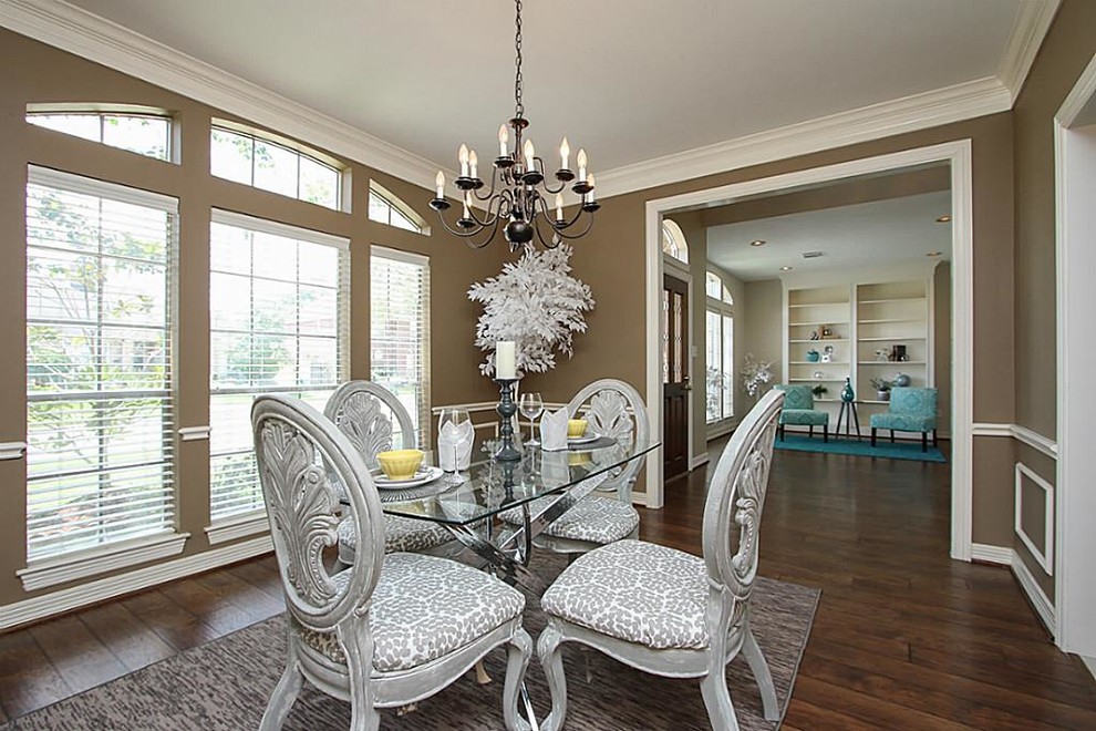 Enclosed dining room - mid-sized transitional dark wood floor and brown floor enclosed dining room idea in Houston with brown walls and no fireplace