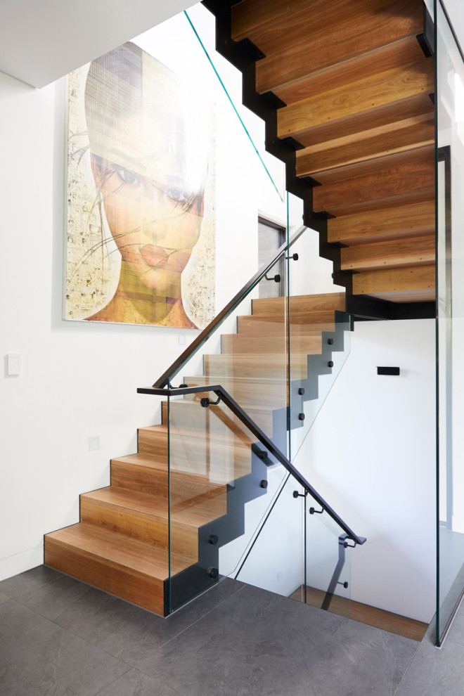 Inspiration for a large industrial wood u-shaped staircase in Melbourne with wood risers and metal railing.