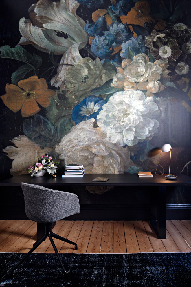 Inspiration for a mid-sized traditional study room in Melbourne with black walls, light hardwood floors, a freestanding desk and brown floor.