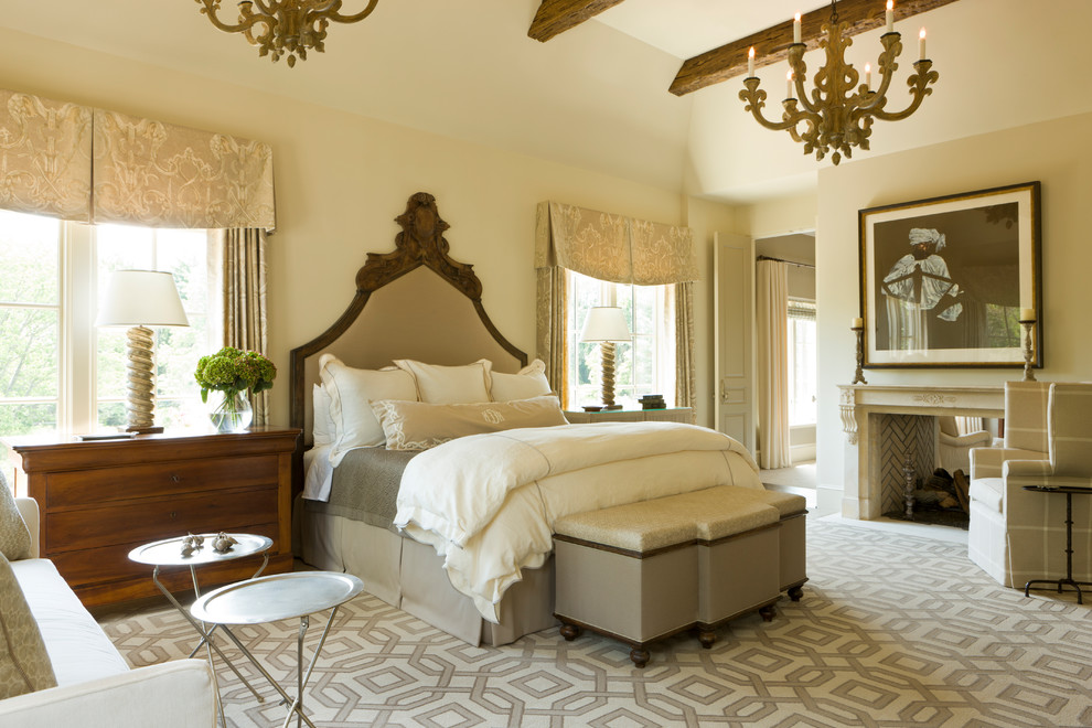 This is an example of a traditional master bedroom in DC Metro with beige walls, a two-sided fireplace, a stone fireplace surround and beige floor.