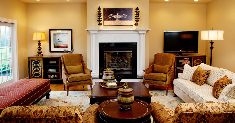 This is an example of a mid-sized traditional formal open concept living room in Birmingham with beige walls, medium hardwood floors, a standard fireplace, a tile fireplace surround, a freestanding tv and brown floor.