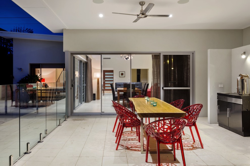 This is an example of a mid-sized contemporary backyard patio in Perth with an outdoor kitchen, concrete pavers and a roof extension.