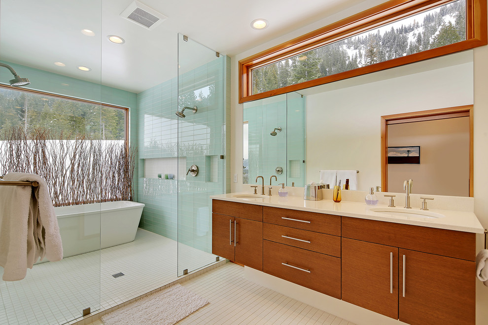Contemporary master wet room bathroom in Seattle with flat-panel cabinets, medium wood cabinets, a freestanding tub, blue tile, glass tile, white walls, an undermount sink, beige floor, an open shower and white benchtops.