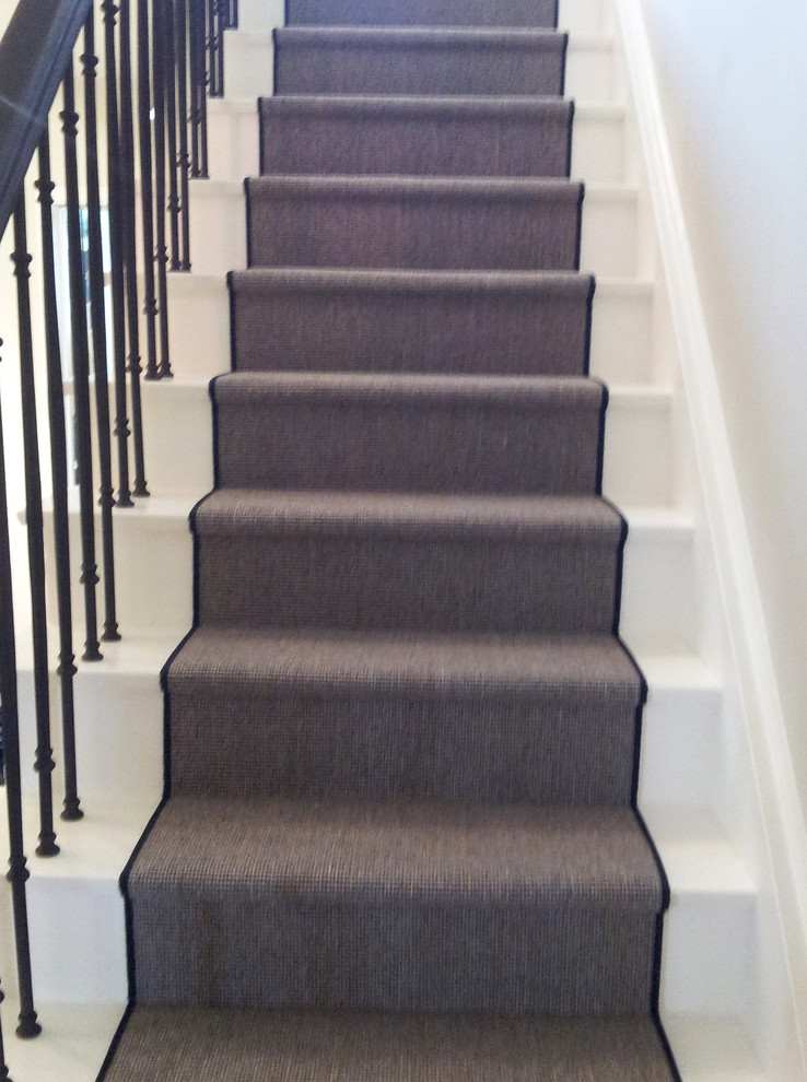 Inspiration for a mid-sized eclectic carpeted straight staircase in Toronto with carpet risers.