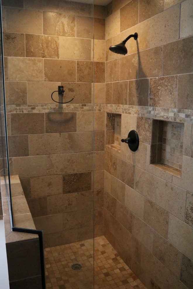 Photo of a mid-sized traditional master bathroom in Minneapolis with raised-panel cabinets, light wood cabinets, a drop-in tub, a corner shower, beige tile, stone tile, travertine floors, an undermount sink and granite benchtops.