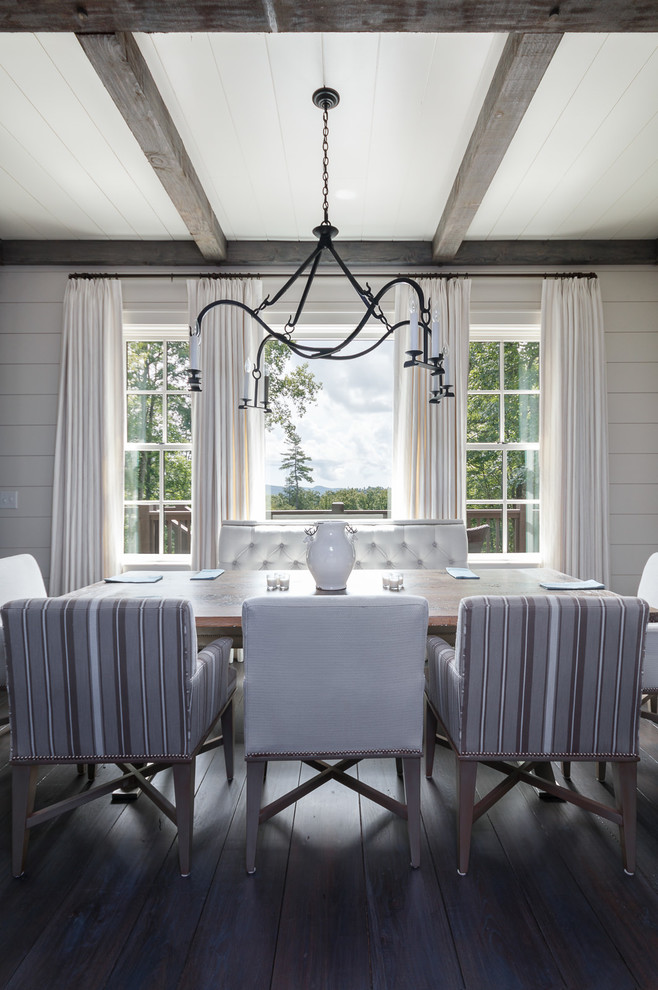 This is an example of a medium sized classic dining room in Charlotte with white walls and dark hardwood flooring.