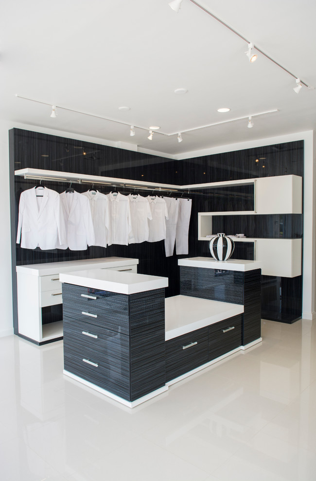 Photo of a small transitional gender-neutral walk-in wardrobe in Los Angeles with black cabinets and flat-panel cabinets.