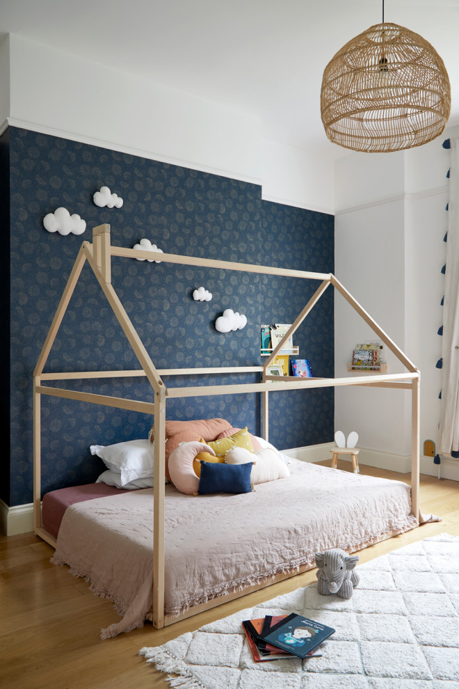 Design ideas for a scandinavian kids' bedroom in West Midlands with a feature wall.