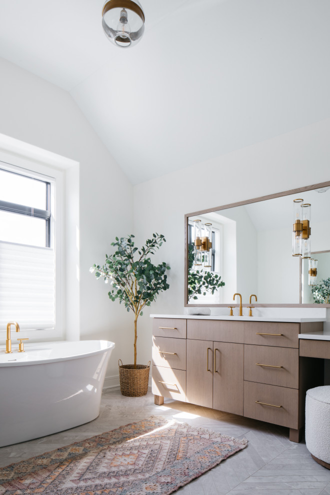 Inspiration for a transitional bathroom in New York with flat-panel cabinets, light wood cabinets, a freestanding tub, white walls, grey floor, white benchtops, a single vanity, a freestanding vanity and vaulted.