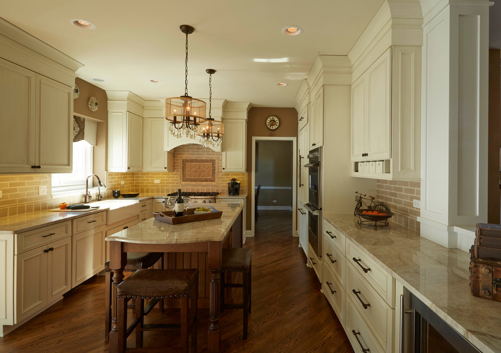 Eat-in kitchen - mid-sized transitional u-shaped medium tone wood floor eat-in kitchen idea in Tampa with a farmhouse sink, white cabinets, quartzite countertops, beige backsplash, ceramic backsplash, paneled appliances and an island